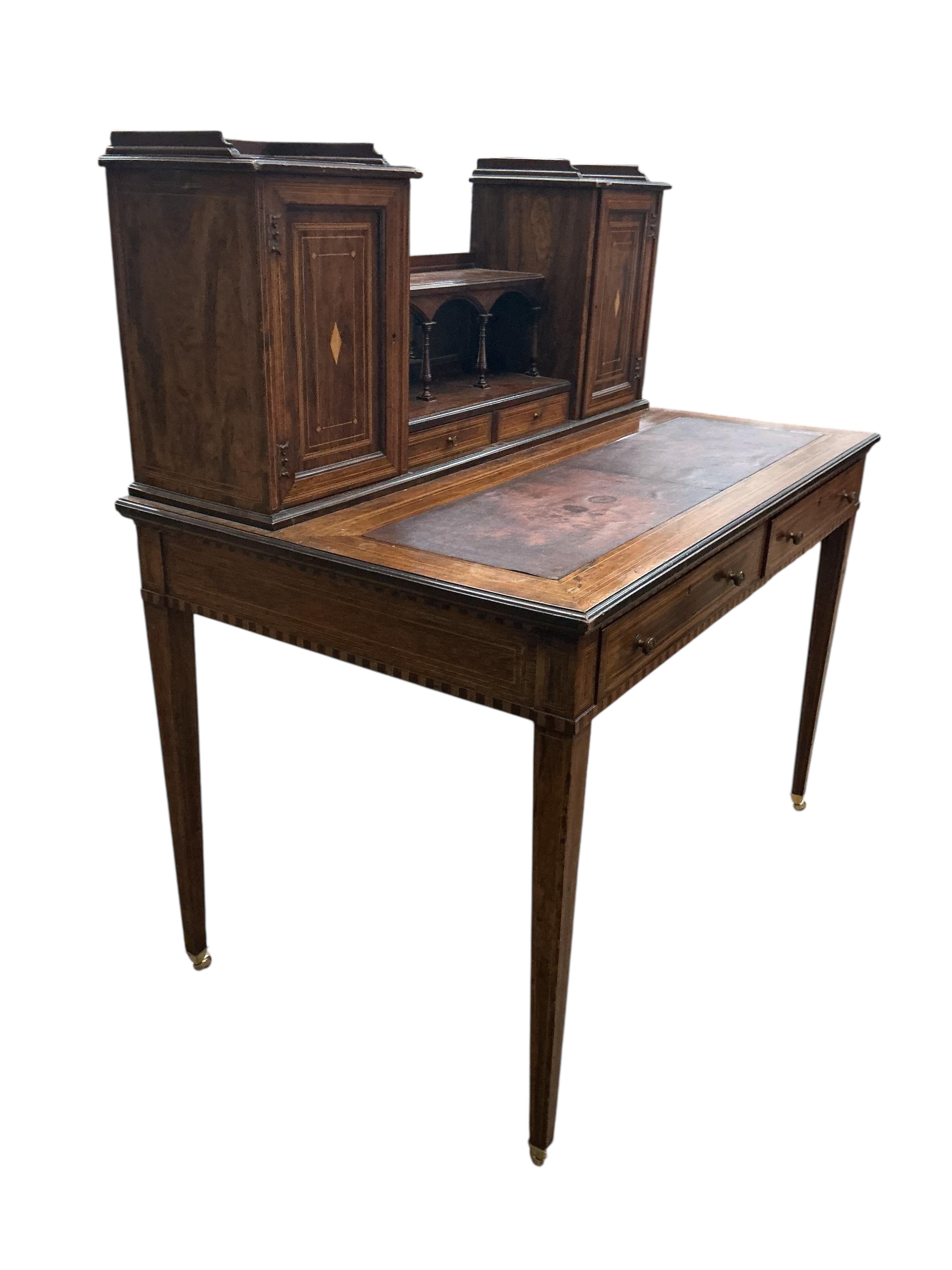 An Edwardian Edwards & Roberts inlaid rosewood desk, width 107cm, depth 66cm, height 114cm